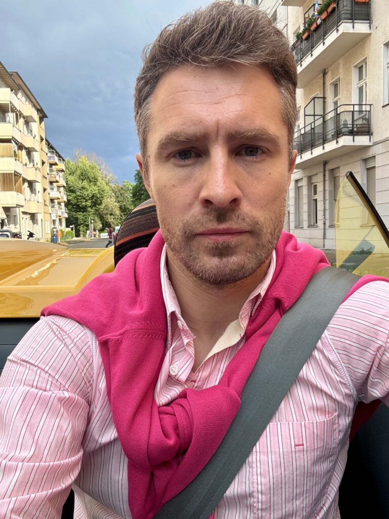 Actor Jan-Martin Müller on set of Drei von der Müllabfuhr in yellow convertable